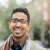 indian-man-smiling-in-city-BLEF12781